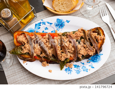 Toast with canned tuna, anchovies and roasted bell pepper Toast with canned tuna, anchovies and roasted bell pepper 141796724