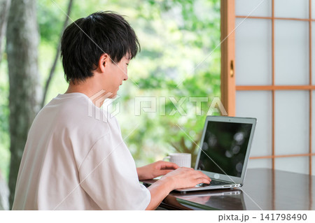 ワーケーション,リモートワークをするアドレスホッパーの若い男性 ワーケーション,リモートワークをするアドレスホッパーの若い男性 141798490