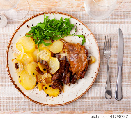 Fried duck confit with roasted potatoes Fried duck confit with roasted potatoes 141798727