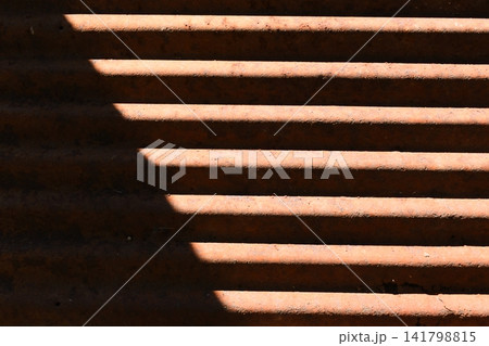 old zinc metal roof background with sunlight, construction industry 141798815