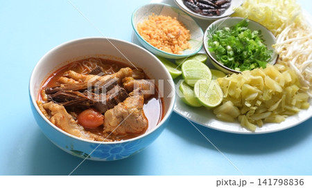 rice vermicelli with northern thai curry sauce on blue background rice vermicelli with northern thai curry sauce on blue background 141798836