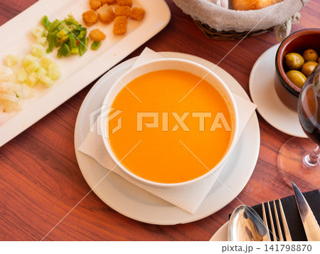 Cold soup gazpacho in bowl served with vegetables and baked breads Cold soup gazpacho in bowl served with vegetables and baked breads 141798870