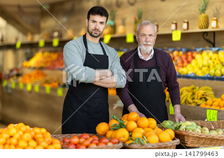 Two male sellers in vegetable shop Two male sellers in vegetable shop 141799463
