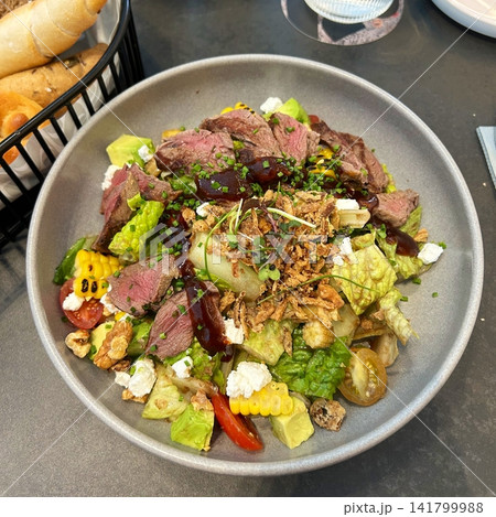 Fresh salad with a mix of crisp leafy greens, sliced vegetables, and colorful ingredients, tossed together to create a healthy, vibrant, and refreshing dish full of natural flavors Fresh salad with a mix of crisp leafy greens, sliced vegetables, and colorful ingredients, tossed together to create a healthy, vibrant, and refreshing dish full of natural flavors 141799988