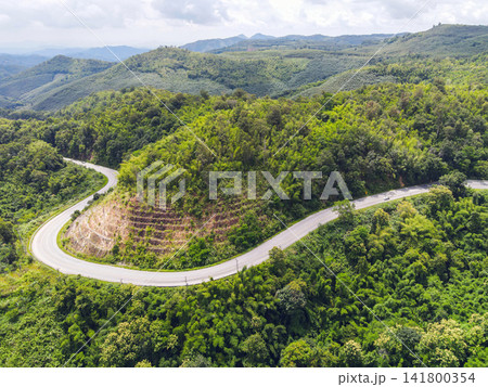 Aerial view forest nature with car on the road on the mountain green tree, Top view road curve from above, Bird eye view road through mountain the green forest beautiful fresh environment 141800354