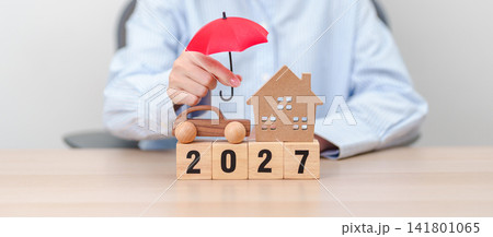 Happy New Year 2027 with red umbrella. Insurance, real estate, Home, car, loan, tax, investment, mortgage, financial, savings, protection and safety Happy New Year 2027 with red umbrella. Insurance, real estate, Home, car, loan, tax, investment, mortgage, financial, savings, protection and safety 141801065