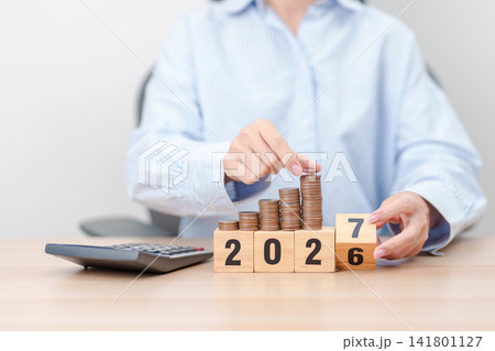 Happy New Year 2027 with calculator.  Resolution, Goals, Plan, Action, Money Saving, Retirement fund, Pension, Investment and Financial concepts 141801127