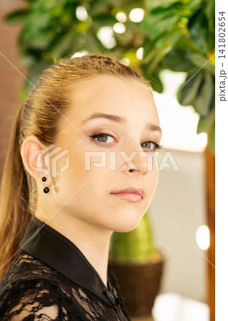 Teen Girl With Finished Makeup Near Illuminated Salon Mirror 141802654