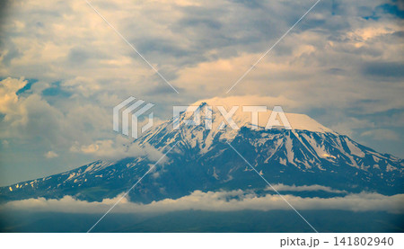 Dramatic mountain peak covered in snow Dramatic mountain peak covered in snow 141802940