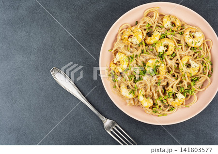 Creamy shrimp spaghetti on plate with fresh chives Creamy shrimp spaghetti on plate with fresh chives 141803577