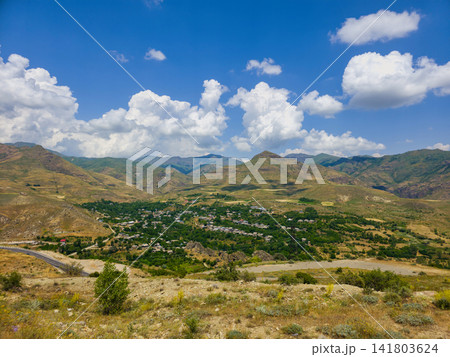 Panoramic view of valley nestled between rolling hills Panoramic view of valley nestled between rolling hills 141803624