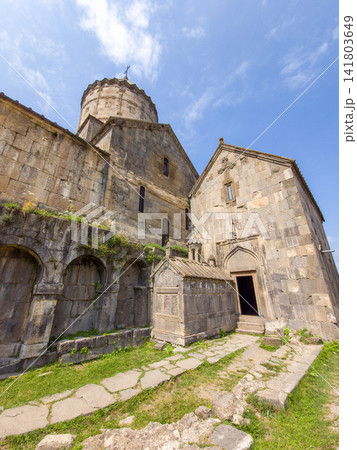 Armenian Tatev monastery complex with arched walkways and open doorway 141803649