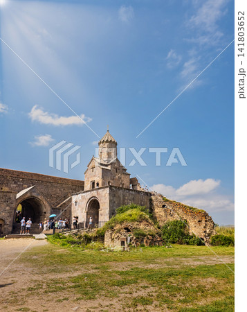 Armenian Tatev monastery with visitors exploring ancient stone walls on sunny da 141803652