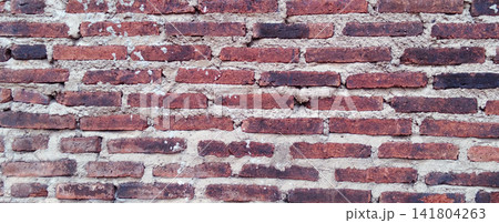 Rustic clay red brick wall texture with a weathered appearance. Rustic clay red brick wall texture with a weathered appearance. 141804263