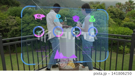 Sharing woman and man wearing jeans, holding glass at round table on balcony, showing HUD rings Sharing woman and man wearing jeans, holding glass at round table on balcony, showing HUD rings 141806250