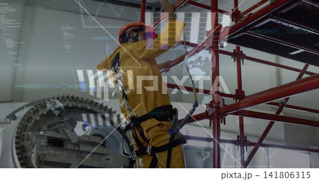 Climbing tech wearing yellow suit, orange hardhat, reaching scaffold beside rotor, wearing harness Climbing tech wearing yellow suit, orange hardhat, reaching scaffold beside rotor, wearing harness 141806315