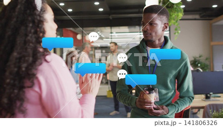 Holding coffee cup, green-sweater man with badge talking to peer at office chat overlay, copy space Holding coffee cup, green-sweater man with badge talking to peer at office chat overlay, copy space 141806326