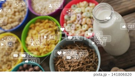 Displaying vibrant cereal bowls and milk bottle on rustic wooden breakfast table, with social icons Displaying vibrant cereal bowls and milk bottle on rustic wooden breakfast table, with social icons 141806820