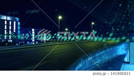 Showing empty highway overpass at night, barrier and lamps reflecting on wet teal glass 141806921