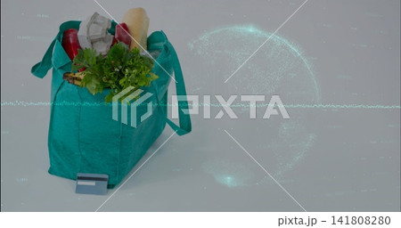 Sitting teal grocery bag holding baguette, card on studio table with data globe overlay, copy space Sitting teal grocery bag holding baguette, card on studio table with data globe overlay, copy space 141808280