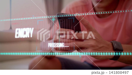 Holding smartphone, coral-shirted man tapping screen on couch at home, with smartwatch and hologram Holding smartphone, coral-shirted man tapping screen on couch at home, with smartwatch and hologram 141808497