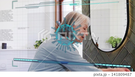 Leaning senior woman rinsing hands at bathroom sink in home bathroom, showing AR virus overlay Leaning senior woman rinsing hands at bathroom sink in home bathroom, showing AR virus overlay 141809487