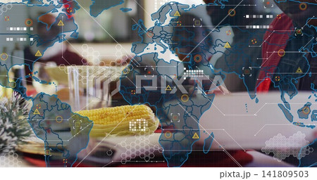 Focusing ear of corn on plate at restaurant, showing map overlay and laptop by red jacket Focusing ear of corn on plate at restaurant, showing map overlay and laptop by red jacket 141809503