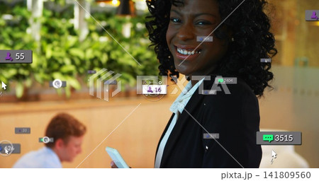 Smiling woman wearing black blazer white blouse holding white phone in office with UI overlays 141809560