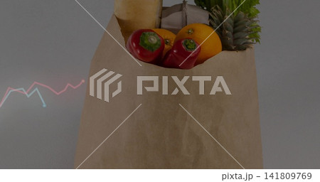 Sitting brown paper bag holding red peppers, orange, baguette, egg carton, greens on gray tabletop Sitting brown paper bag holding red peppers, orange, baguette, egg carton, greens on gray tabletop 141809769