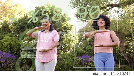 Holding gestures, two women in pink tops on garden lawn with AR overlays showing ANALYSING DATA Holding gestures, two women in pink tops on garden lawn with AR overlays showing ANALYSING DATA 141810241