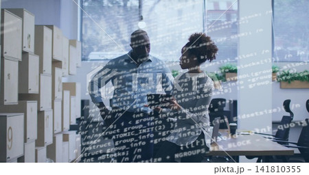Discussing man in shirt, woman in blouse pointing tablet in office, code overlay, numbered cubbies Discussing man in shirt, woman in blouse pointing tablet in office, code overlay, numbered cubbies 141810355