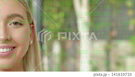 Smiling left adult woman revealing nose ring and stud earring in woods, binary code, copy space 141810710