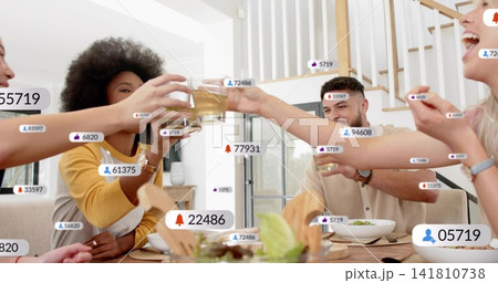 Clinking four adults with mustard sweater raising glasses at home wooden table with salad, overlays Clinking four adults with mustard sweater raising glasses at home wooden table with salad, overlays 141810738