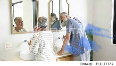 Touching cheek, striped-top woman and blue-T-shirt man leaning at bathroom double vanity, overlay 141811123
