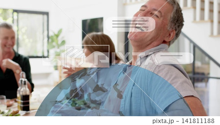 Laughing man leaning and chatting in home dining room, with wine bottle and globe speech bubbles Laughing man leaning and chatting in home dining room, with wine bottle and globe speech bubbles 141811188
