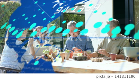 Potting four hobby gardeners wearing casual clothes around wooden table on patio with blue overlay Potting four hobby gardeners wearing casual clothes around wooden table on patio with blue overlay 141811190