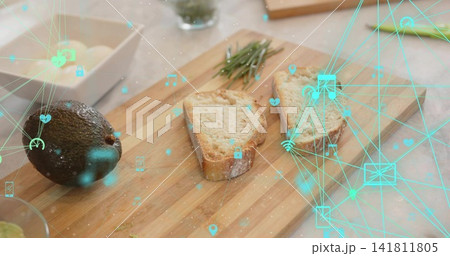Displaying wooden board with rustic bread, avocado, rosemary, crumbs on stone counter, teal overlay Displaying wooden board with rustic bread, avocado, rosemary, crumbs on stone counter, teal overlay 141811805