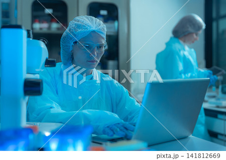 Agricultural biotechnology experiment by female scientists for medicine discovery. 141812669