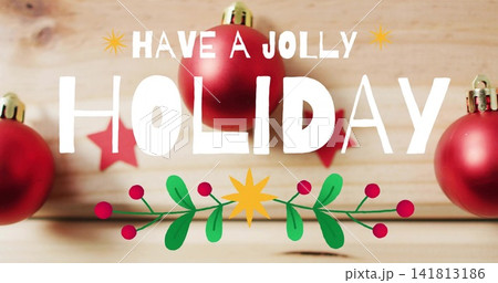 Displaying white hand-lettered greeting centered on wood plank backdrop, showing red glossy baubles Displaying white hand-lettered greeting centered on wood plank backdrop, showing red glossy baubles 141813186