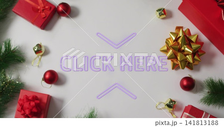 Glowing purple neon CLICK HERE chevrons centering on white table, framing red gifts, gold-bow, pine 141813188