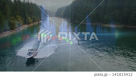 Cutting motorboat towing wakeboard rider in vest on treed lake pulling tow rope leaving wake charts 141813412