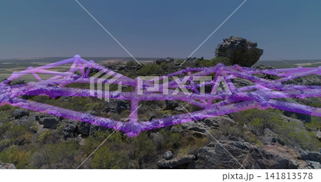 Displaying rocky plateau featuring perched boulder and purple mesh draping over terrain Displaying rocky plateau featuring perched boulder and purple mesh draping over terrain 141813578