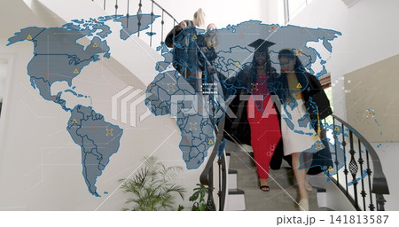 Descending grads in gowns and caps on curved stairs in atrium, red dress visible, world-map overlay Descending grads in gowns and caps on curved stairs in atrium, red dress visible, world-map overlay 141813587