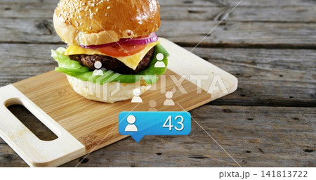 Showcasing sesame bun burger with onion tomato cheese lettuce on wood board with avatars showing 43 Showcasing sesame bun burger with onion tomato cheese lettuce on wood board with avatars showing 43 141813722