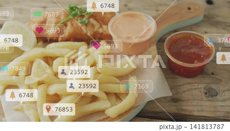 Showing paddle holding French fries, fried fish, lemon wedge, two sauces on wooden table, icons Showing paddle holding French fries, fried fish, lemon wedge, two sauces on wooden table, icons 141813787