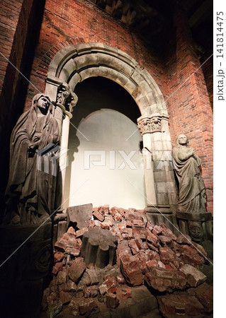 Damaged historic church ruins with statues and rubble from the atomic bombing in Nagasaki displayed in museum. 141814475