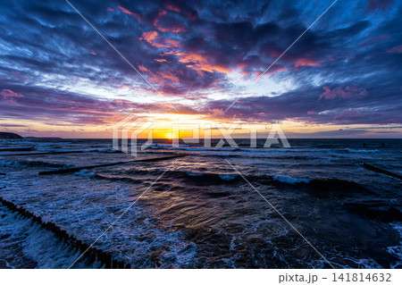 Scenic sundown on the sea shore with a breakwaters Scenic sundown on the sea shore with a breakwaters 141814632