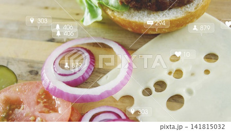 Displaying red onion rings centered on wooden cutting board with cheese, tomato, pickle, bun, icons Displaying red onion rings centered on wooden cutting board with cheese, tomato, pickle, bun, icons 141815032