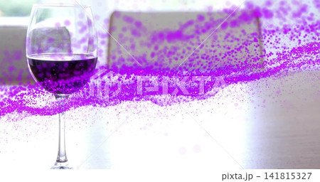 Showing stemmed glass holding dark red wine reflecting on kitchen table, purple streak, copy space Showing stemmed glass holding dark red wine reflecting on kitchen table, purple streak, copy space 141815327
