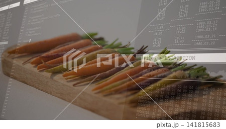 Displaying row of baby carrots with green tops on wooden board, showing File  ENCRYPTION overlay 141815683